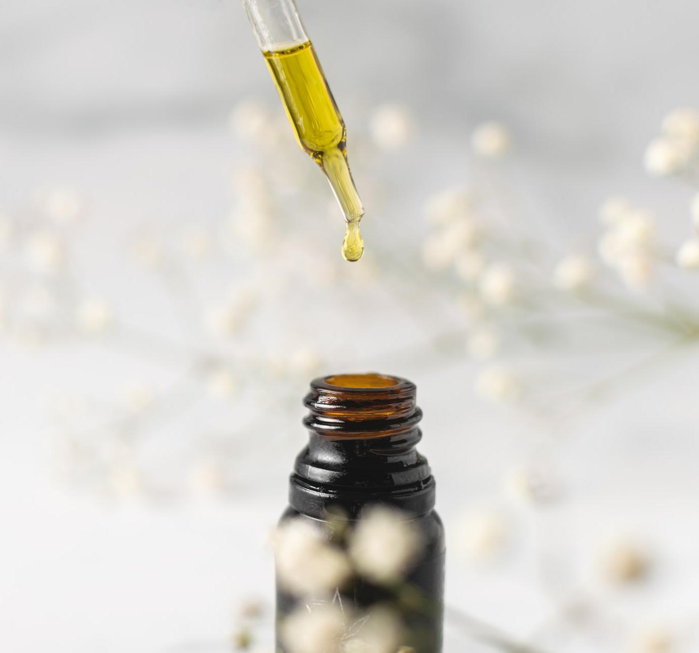 clear glass bottle with yellow lid